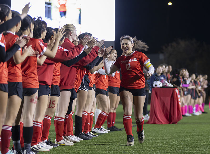 Soccer player giving high fives to their team